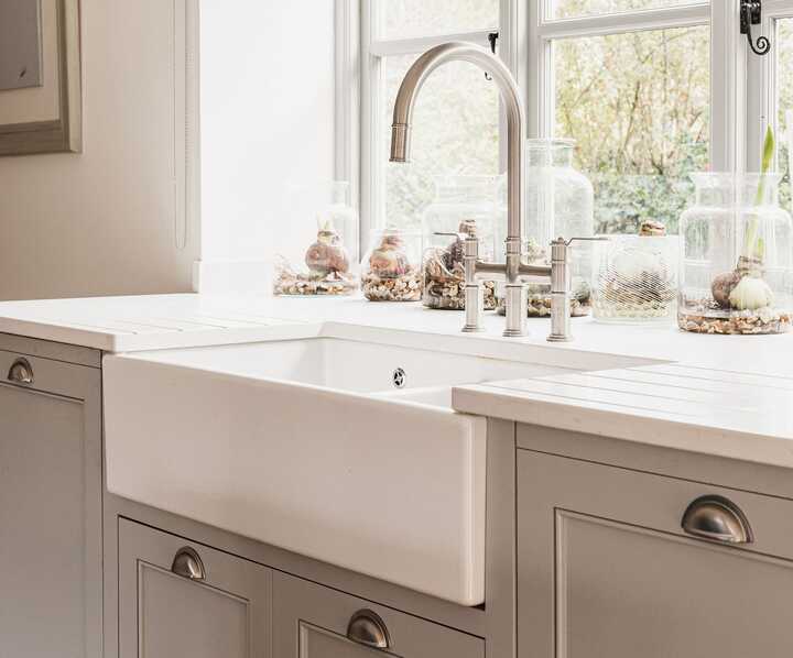 Belfast sink situated in a modern kitchen with bespoke cabinets